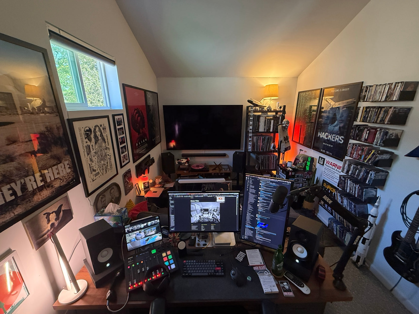 Bill’s workspace with displays, audio equipment, framed posters, and shelves of physical media.